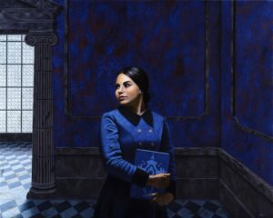 Woman standing holding a book in a room with blue walls